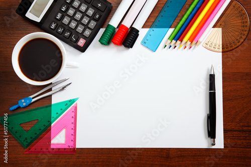 Desk with sheet of paper and stationery objects