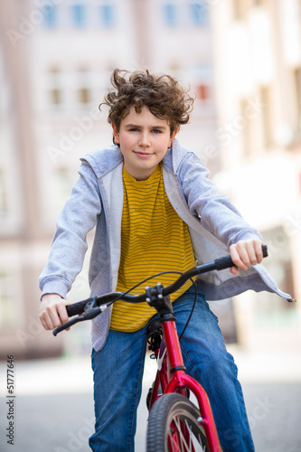 Urban biking - teenage boy and bike in city