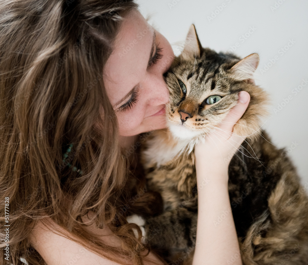 beautiful smiling brunette girl and her  cat over
