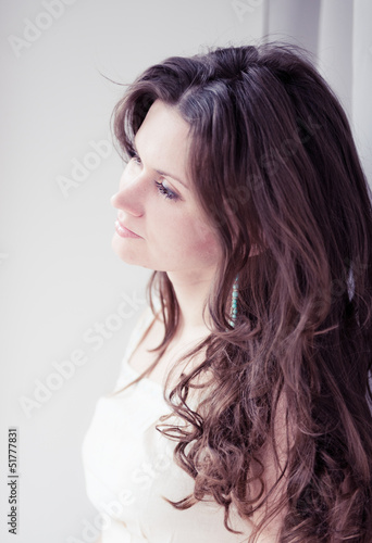 Portrait of beautiful young happy smiling woman with long curly