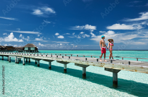 Couple on a beach jetty at Maldives