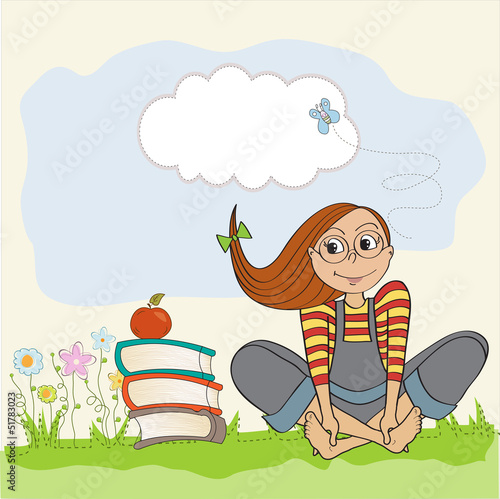 studious girl sitting barefoot in the grass