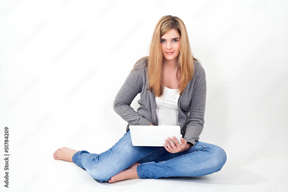 young woman working on laptop while sitting on the floor young woman working on laptop while sitting on the floor