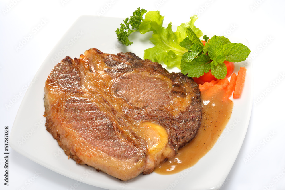 Grilled beef steak with vegetables and gravy sauce Grilled beef steak with vegetables and gravy sauce
