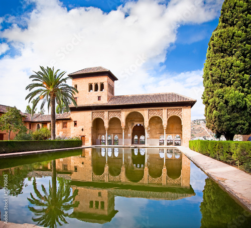 Alhambra palace reflected in water in Granada. Spain.