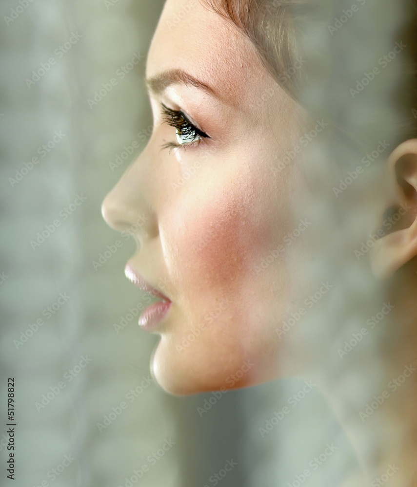 A beautiful woman, portrait isolated on grey background A beautiful woman, portrait isolated on grey background