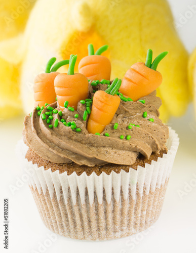 Easter cupcake with carrots decoration and chocolate cream