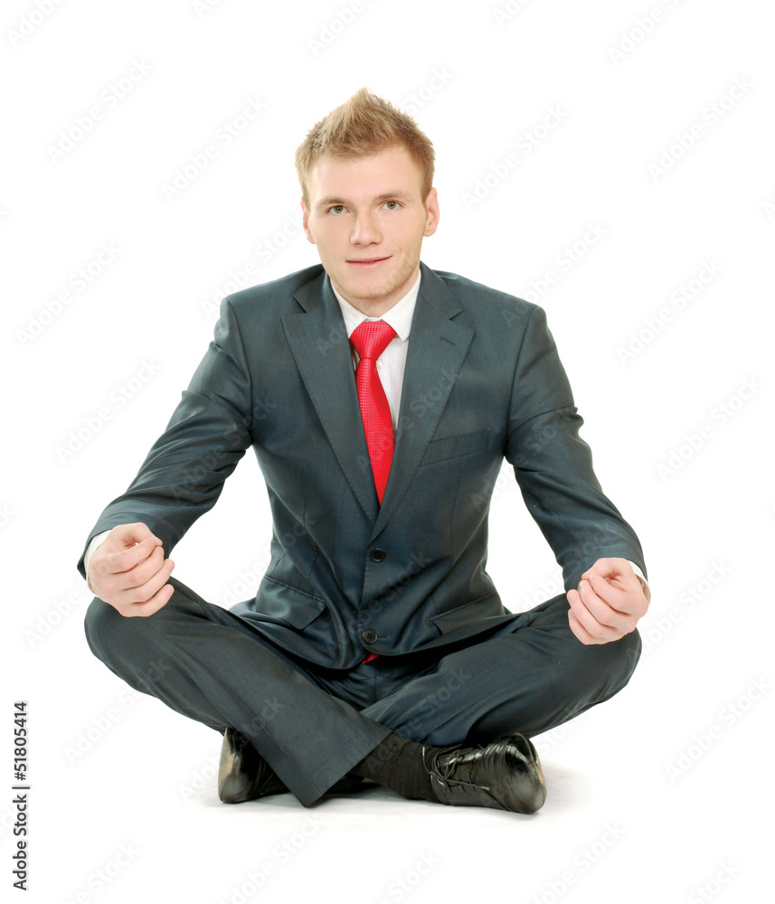 A young guy sitting on the floor, isolated on white background A young guy sitting on the floor, isolated on white background