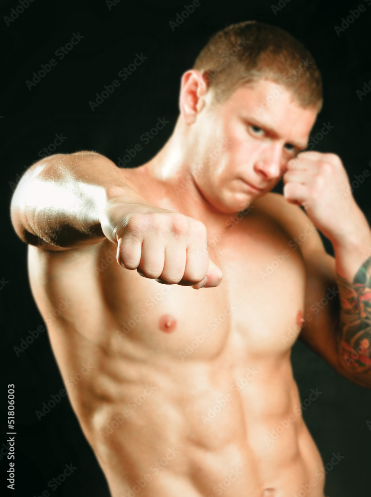 Portrait of boxer on black background