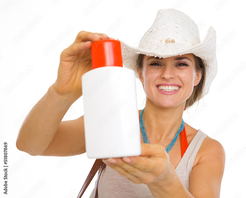 Smiling beach young woman showing sun block creme Smiling beach young woman showing sun block creme