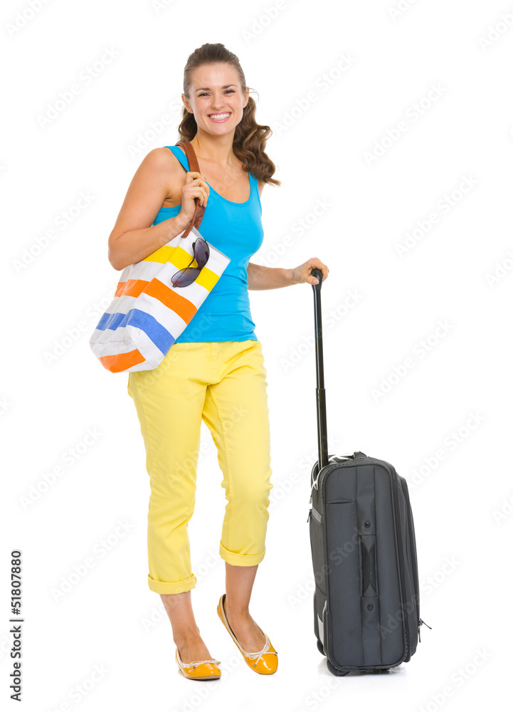 Full length portrait of happy young tourist woman with wheel bag Full length portrait of happy young tourist woman with wheel bag