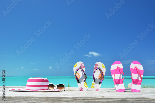 Hat, sunglasses and flip-flops on the beach of Exuma, Bahamas