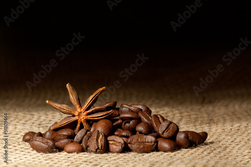 Coffee and Star Anise on sackcloth background with copyspace
