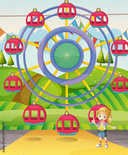 A girl below the ferris wheel