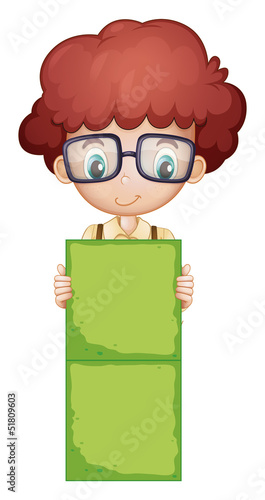 A boy holding a green signage