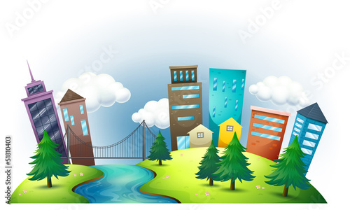 A hill with a river across the tall buildings