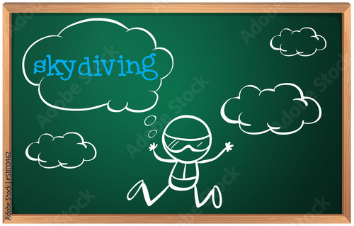A blackboard with a drawing of a boy sky diving