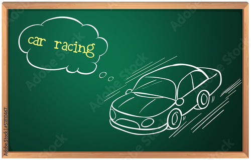 A blackboard with a drawing of a car racing