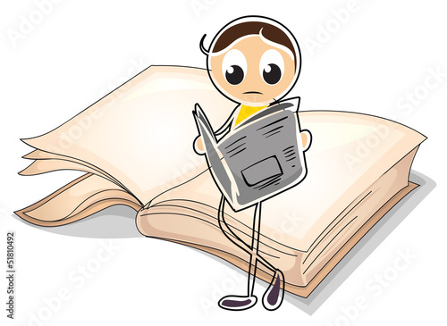 A girl reading in front of a big book