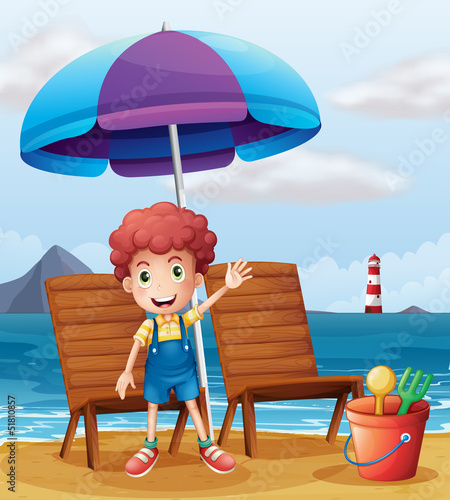 A young boy standing at the beach