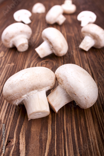champignons on a wooden background, selective focus