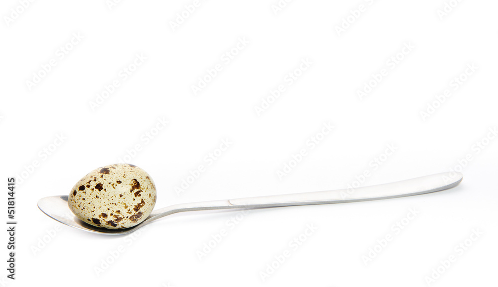 Quail egg on a spoon