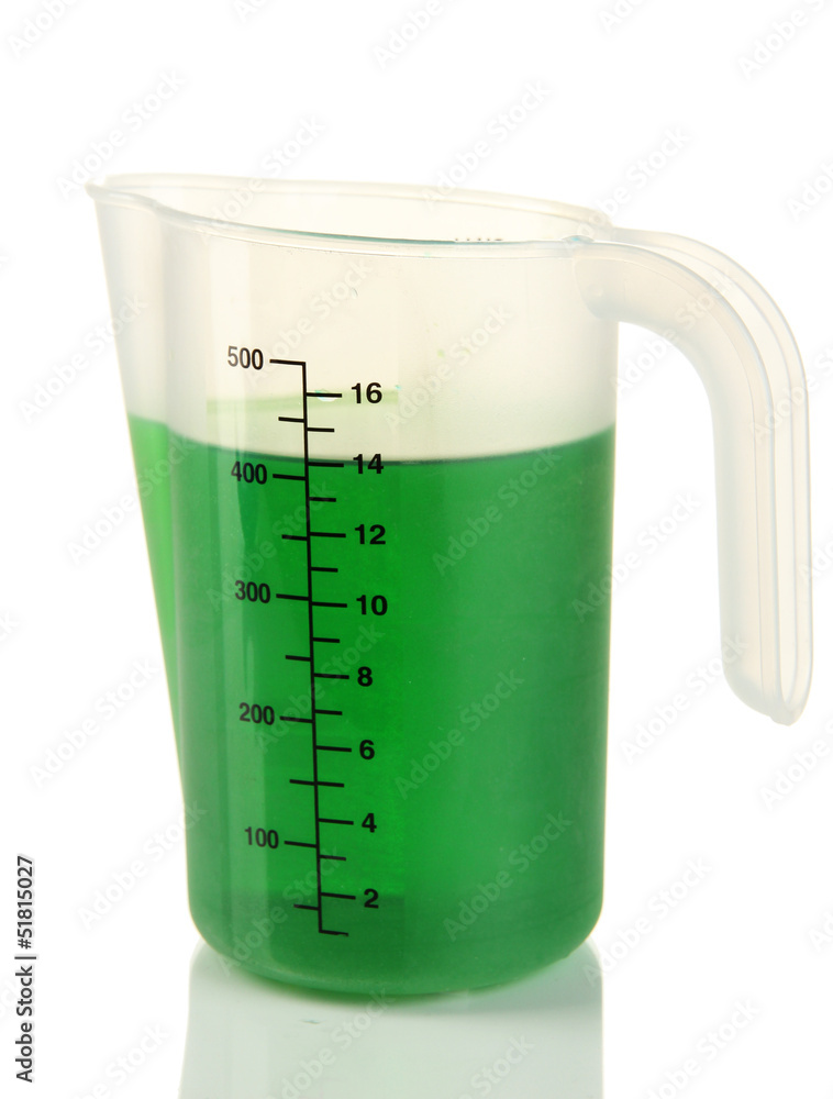 Measuring cup with green liquid isolated on white Measuring cup with green liquid isolated on white