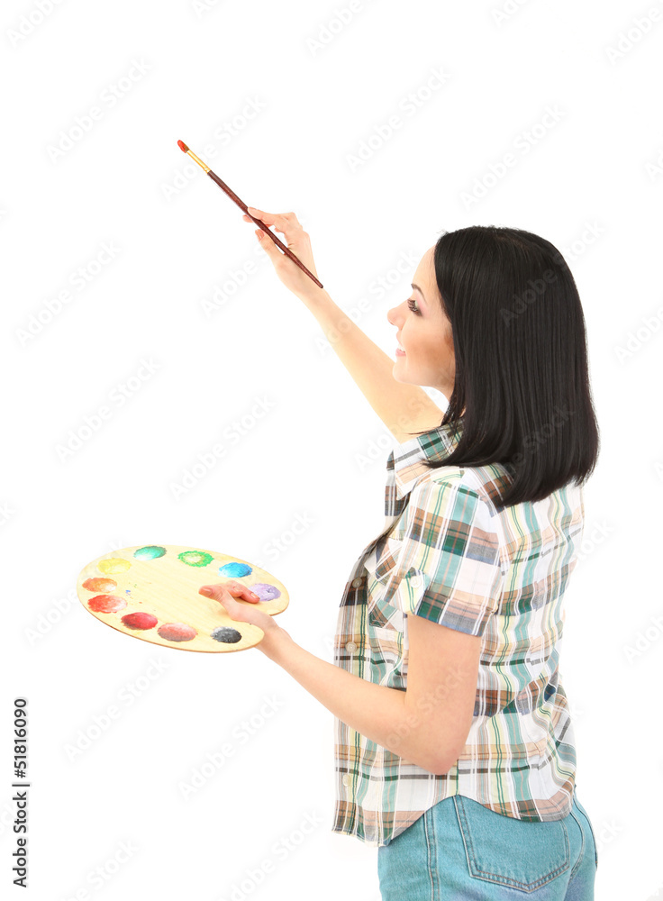 Fototapeta premium Beautiful young woman painter with brushes and palette at work,