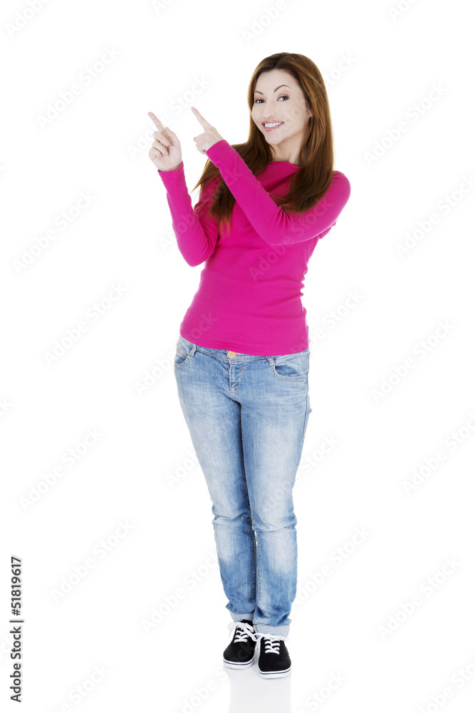 Happy , excited woman pointing on copy space Happy , excited woman pointing on copy space