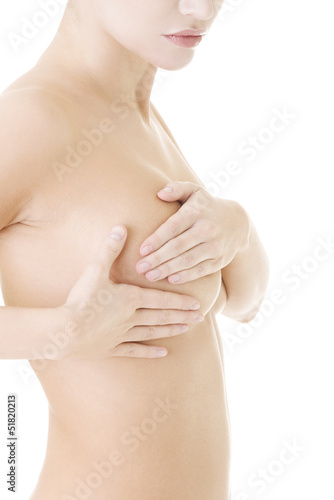 Caucasian adult woman examining her breast