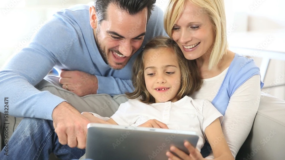 Parents and child playing with tablet Parents and child playing with tablet