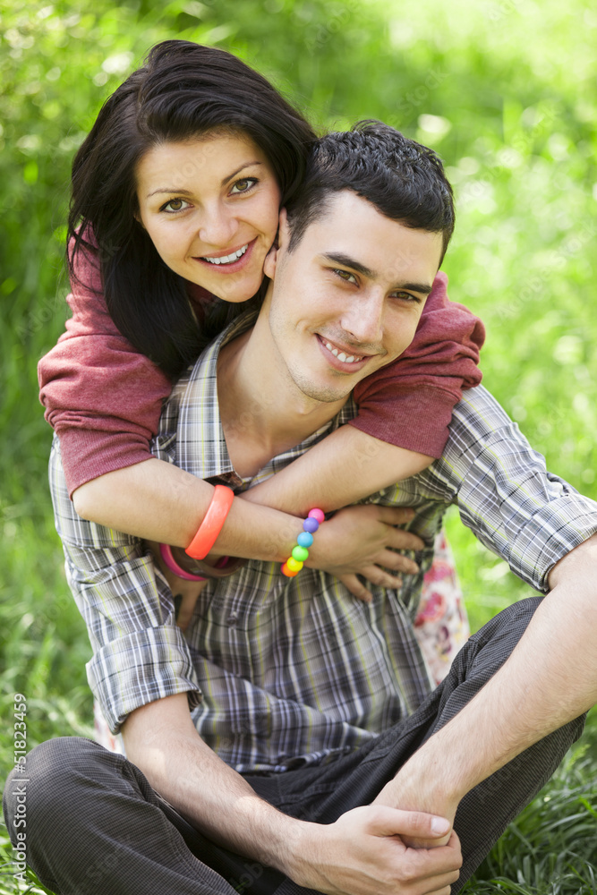 Fototapeta premium Couple Relaxing on Green grass