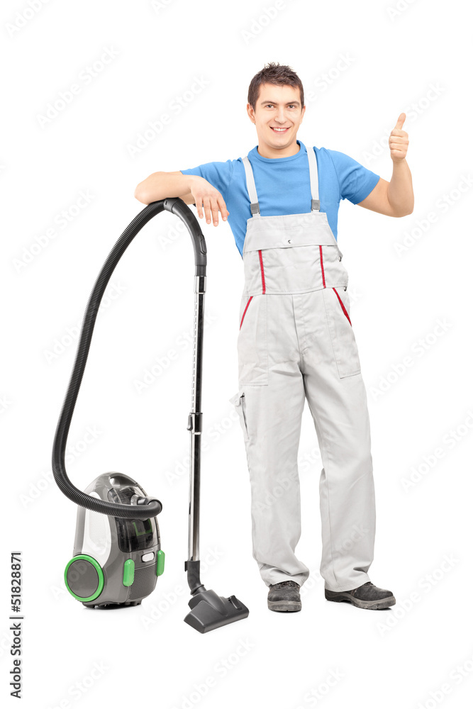 Full length portrait of a male cleaner with a vacuum cleaner giv Full length portrait of a male cleaner with a vacuum cleaner giv