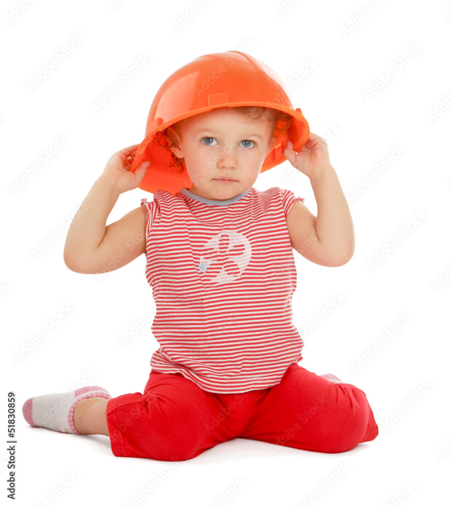 Portrait of a little girl in helmet sitting on the floor Portrait of a little girl in helmet sitting on the floor
