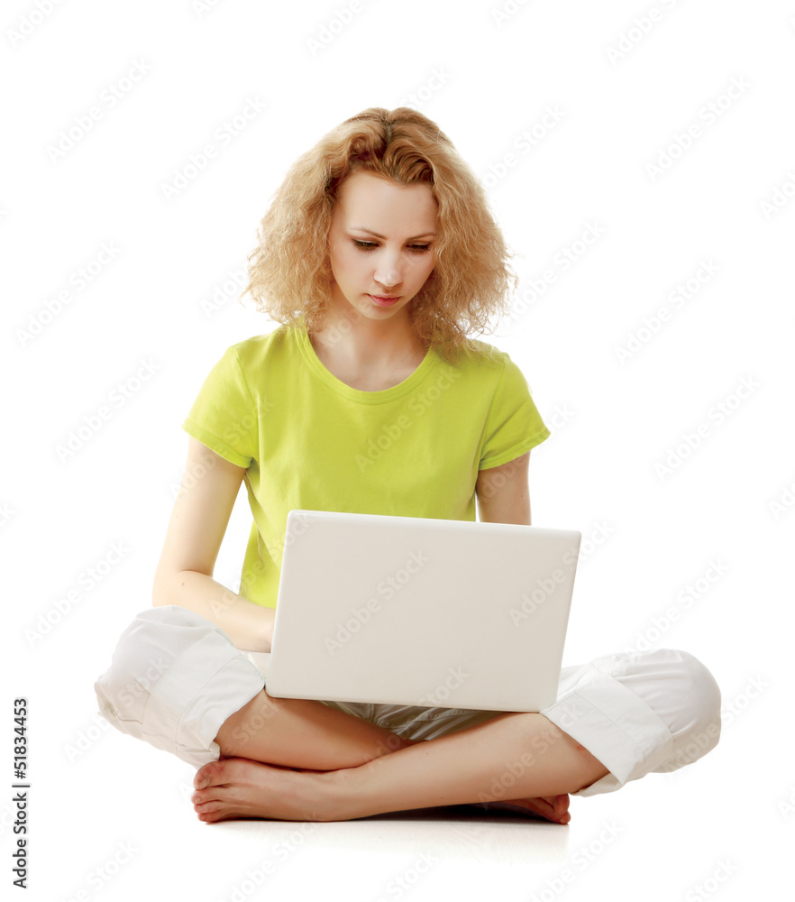 A young girl sitting on the floor with a laptop A young girl sitting on the floor with a laptop