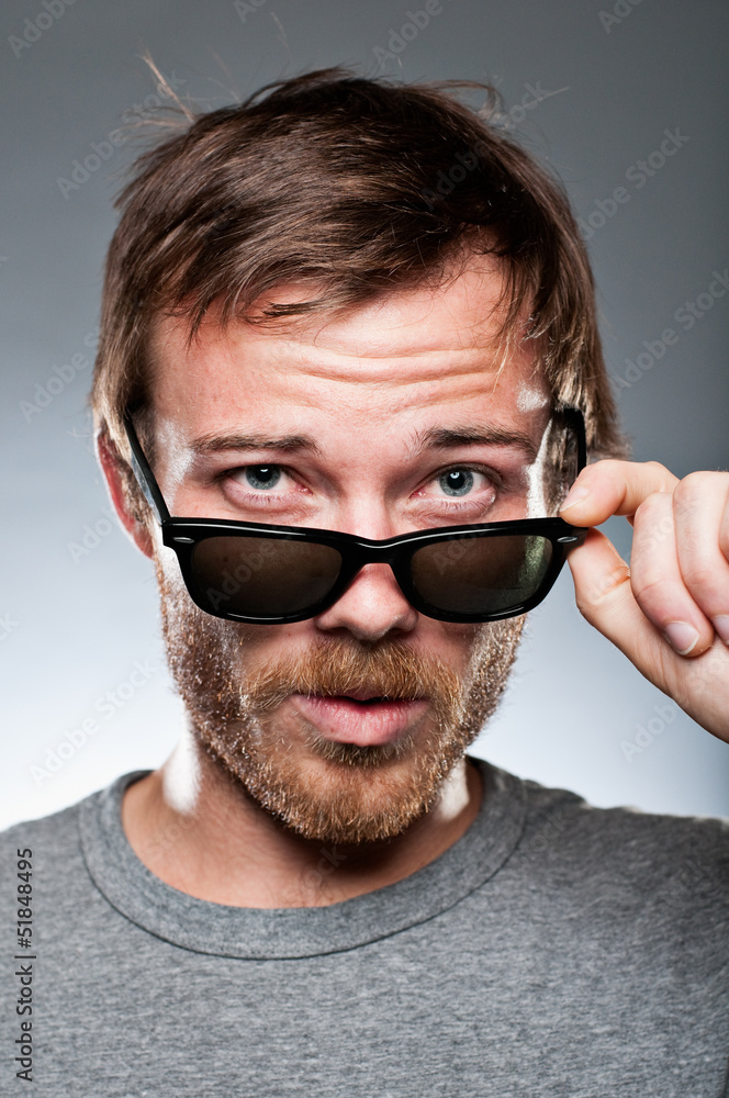 Caucasian Man Looking Over His Sunglasses Caucasian Man Looking Over His Sunglasses