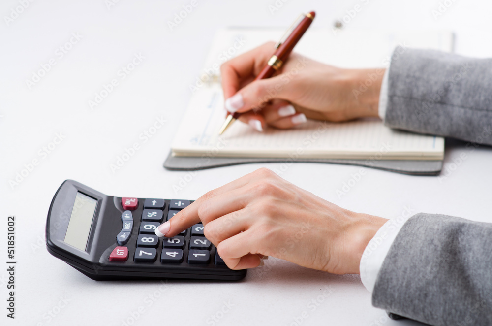 Hands working on the calculator Hands working on the calculator
