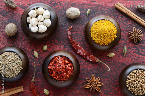 Set of various Indian spices on rusted wooden background