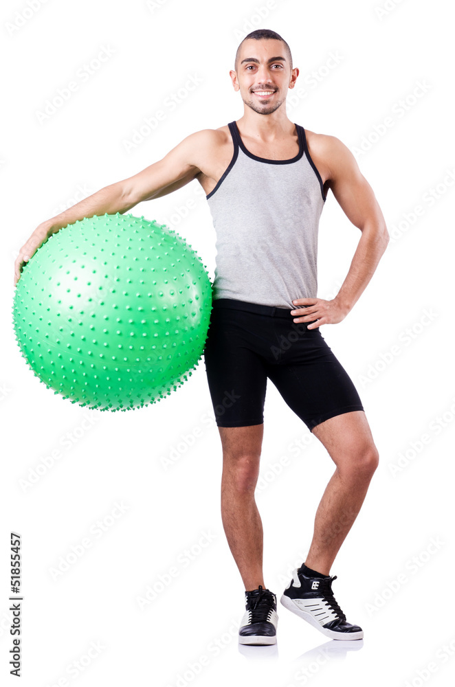 Man with swiss ball doing exercises on white