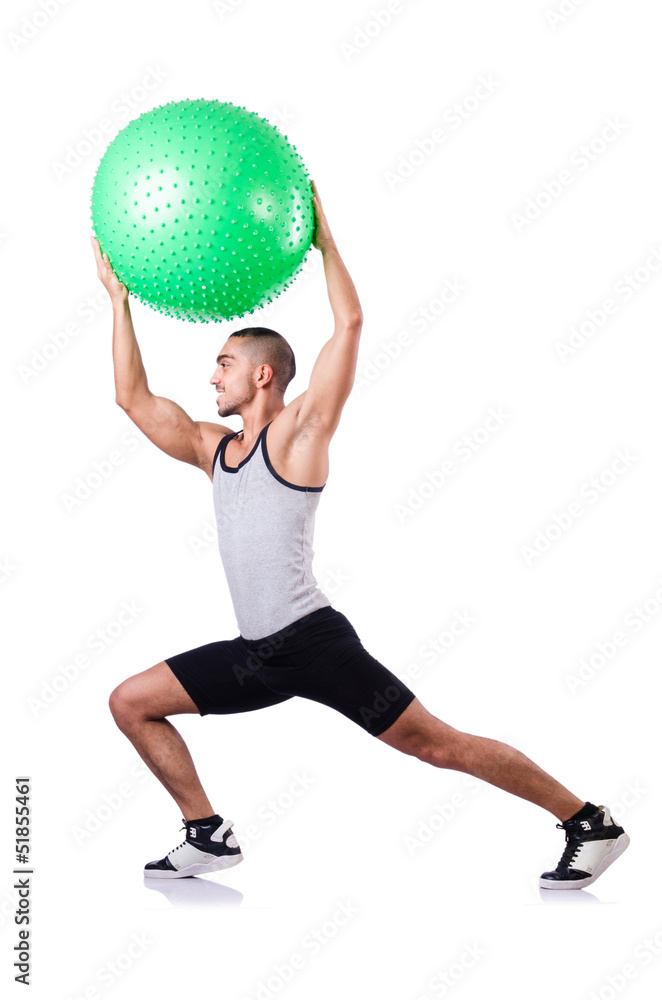 Man with swiss ball doing exercises on white