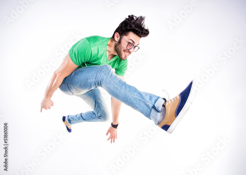 Картината върху платно handsome man dressed casual jumping and smiling  - dynamic wide