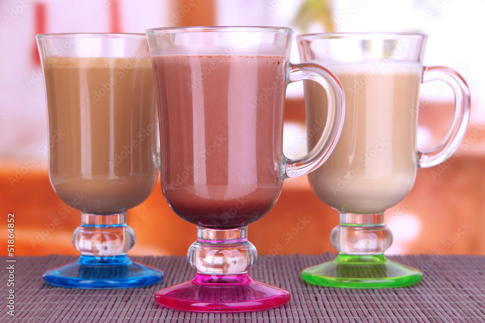 Layered coffee in glass on table on bright background Layered coffee in glass on table on bright background
