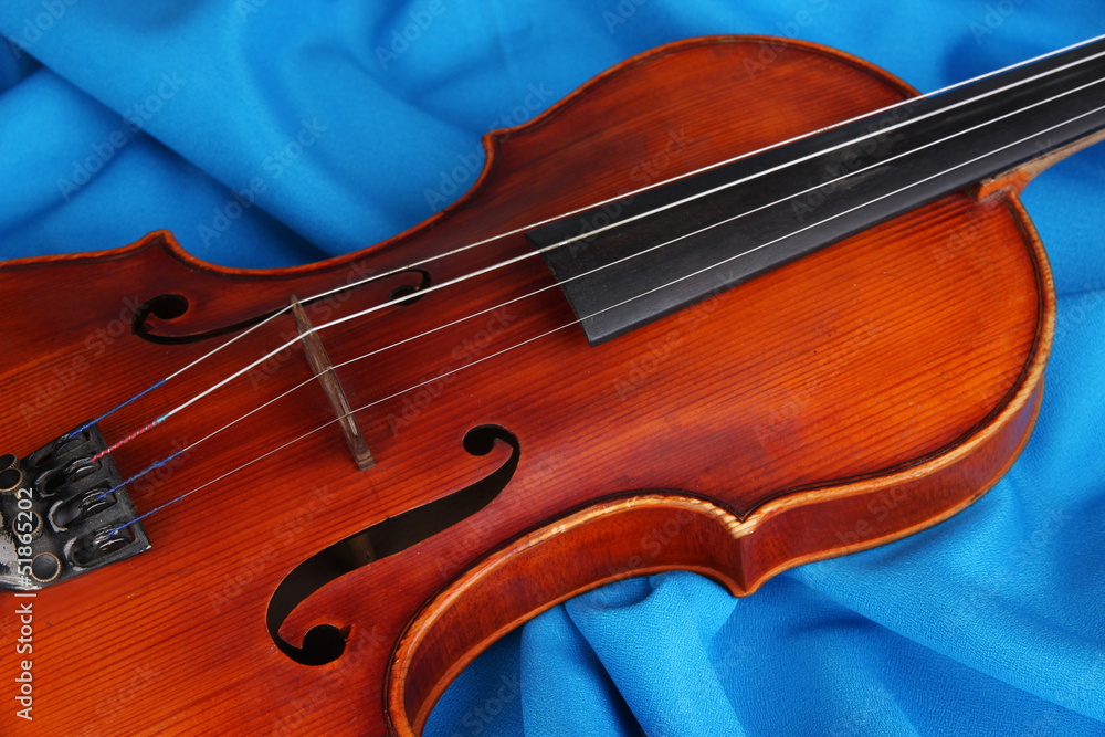 Classical violin on fabric background Classical violin on fabric background