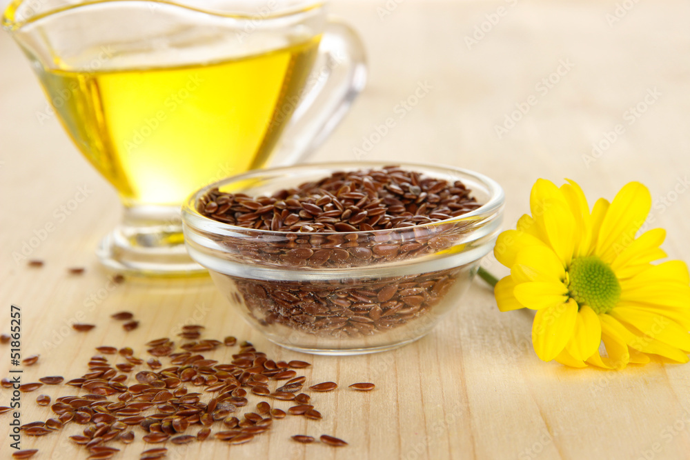 Useful linseed oil on wooden table close-up Useful linseed oil on wooden table close-up