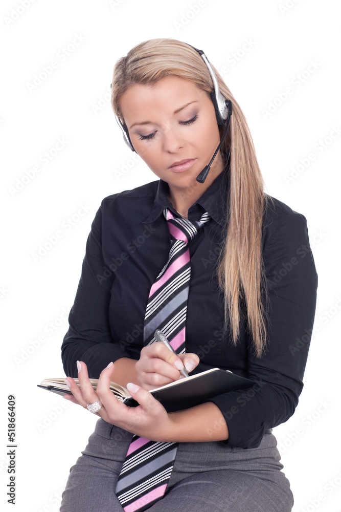 Secretary wearing a headset writing notes Secretary wearing a headset writing notes