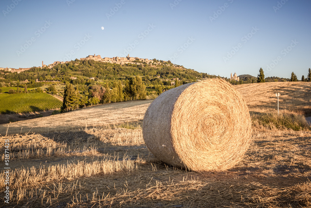 Bale of hay, in the background Montepulciano, Tuscany