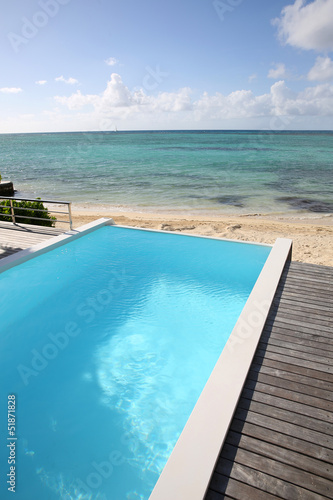 Beautiful view of infinity pool with wooden deck © goodluz
