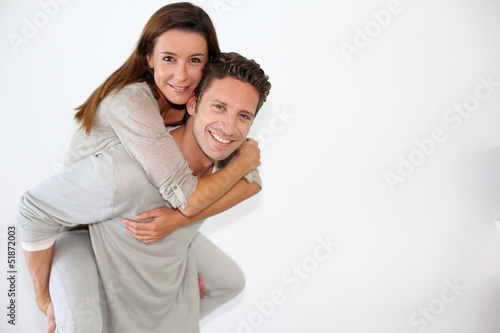 Handsome guy giving piggyback ride to girlfriend