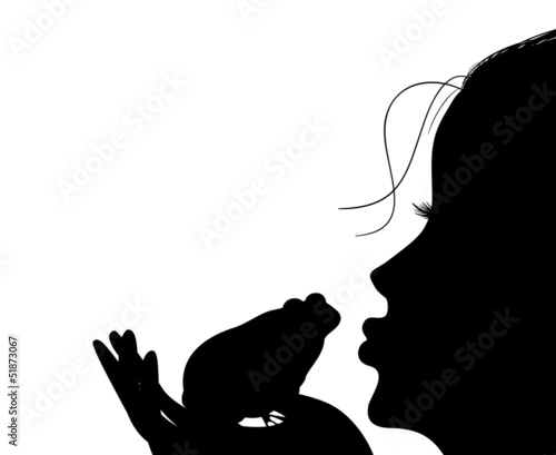 Silhouette of a young girl kisses a frog
