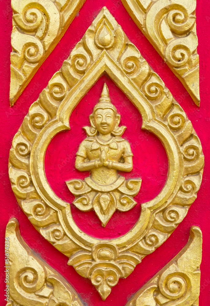 A deity sculpture on Thai temple wall